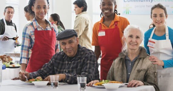 Volunteers serving food at community kitchen